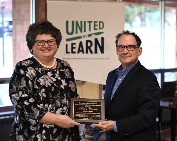 Picture of a man handing a woman a plaque.