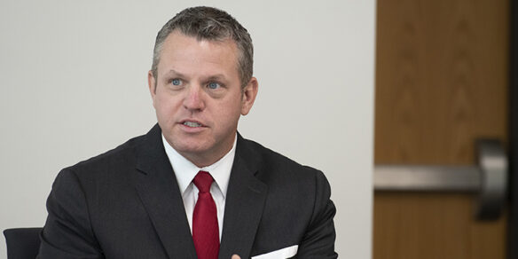 A picture of a man wearing a suit and talking.