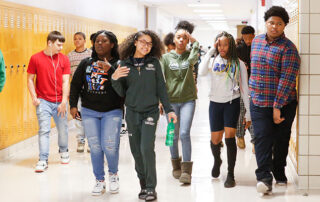 Picture of a group of students walking down a hallway.