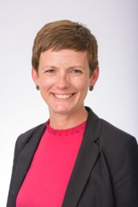 A headshot photo of a woman smiling.
