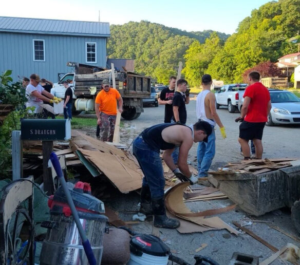 A group of people cleaning up debris. 