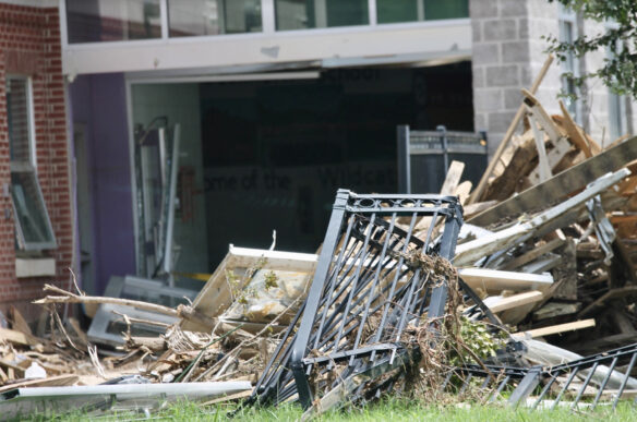 Debris in front of a damaged building.