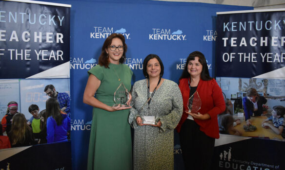 A picture of Kelly Gates, Mandy Perez and Amber Sergent holding glass trophies.