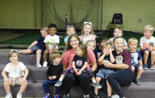Carlisle County preschool students and Carlisle PALs participants sit on steps and smile.