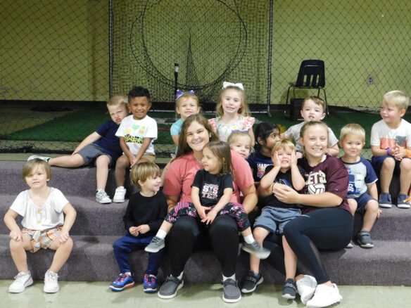 Carlisle County preschool students and Carlisle PALs participants sit on steps and smile. 