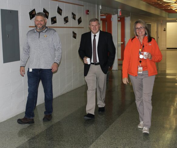 John Slone walks down a hallway in the Williamstown Independent School District.