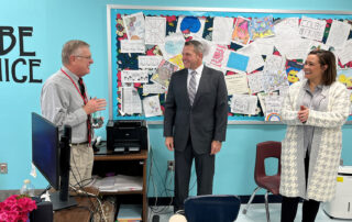 A picture of Michael Wright smiling and talking to Jason E. Glass and Jacqueline Coleman while standing in a classroom.