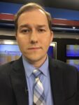 Picture of Kentucky Teacher editor Joe Ragusa, wearing a dark blazer, light blue shirt and blue striped tie.