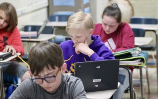 Students sit at desks in a classroom