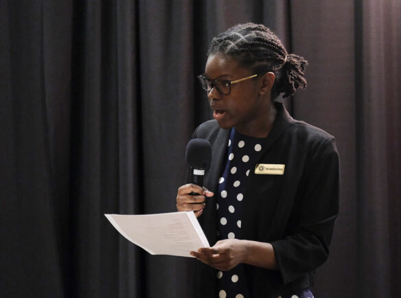 A woman speaks into a microphone