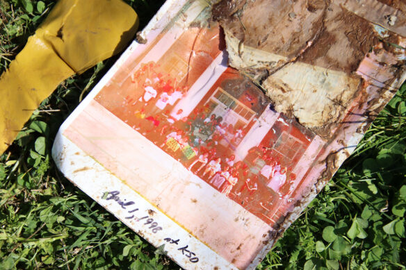 A wet and moldy photo shows a group of people posing in front of a building with the words April 1, 1998 at KSD written at the bottom