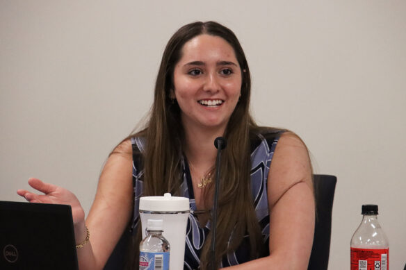 Picture of Joud Dahleh sitting at a conference table, talking and smiling.