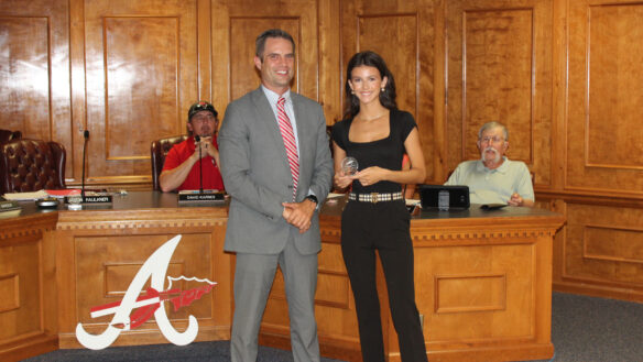 Adair County Superintendent Jason Faulkner stands and smiles with a student