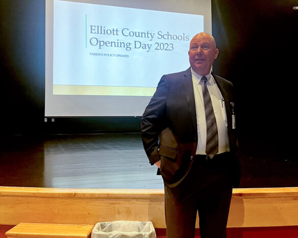 Michael Melton stands in front of a projected powerpoint presentation that reads Elliott County Opening Day 2023