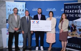 A picture of Kevin Dailey holding a large fake check, with Jon Caldwell, Jason Glass, Lt. Gov. Jacqueline Coleman and Laura Pentova.