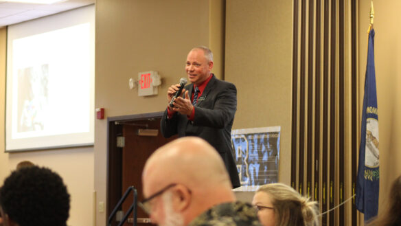 Kyle Estes speaks at a podium