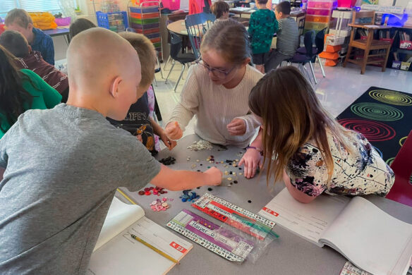 A group of students works around a table