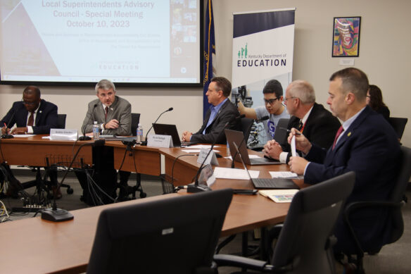 Members of the Local Superintendents Advisory Council sit around tables and talk to each other