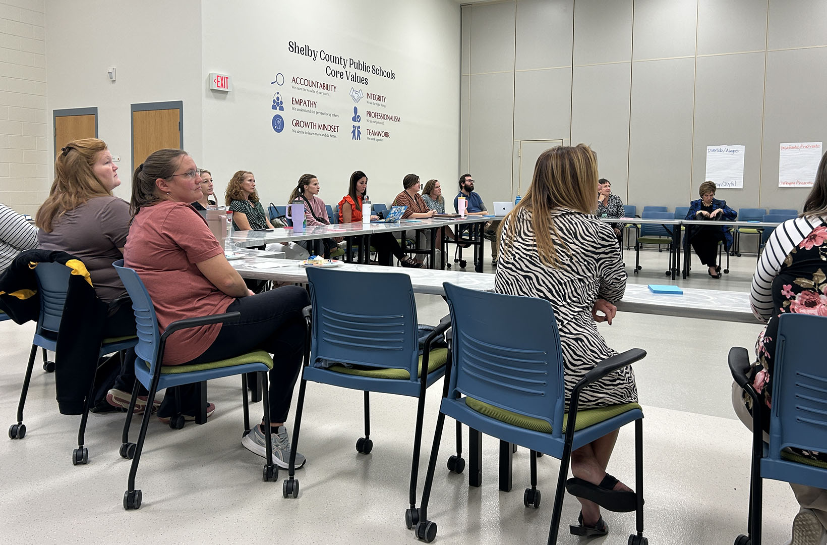 A group of educators in a room listening