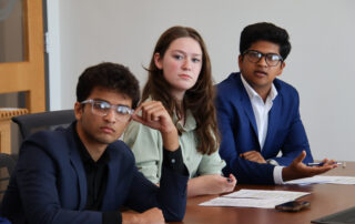 Shraman Kar, Sophia Staples and Vijay Karthikeyan talk during a Student Advisory Council meeting
