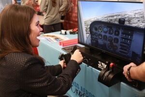 girl smiling while using a flight simulator