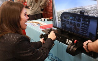 one girl playing on an interactive flight simulator