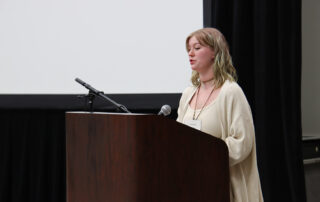 A student speaks at a podium
