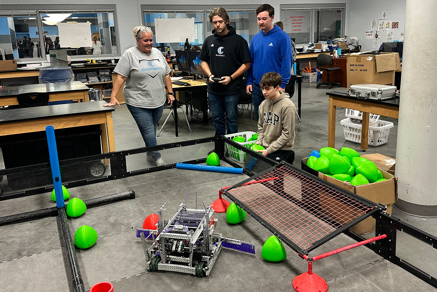 Laura Smith and members of her robotics team practice with the robots