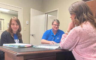 Breathitt County District Literacy Specialist Fannie Hall studies the LETRS for Administrators manual with Chief Academic Officer Timothy Wooton and Curriculum Specialist Nancy Eversole. Submitted photo.