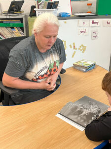 Wanda Nobel helps a student read