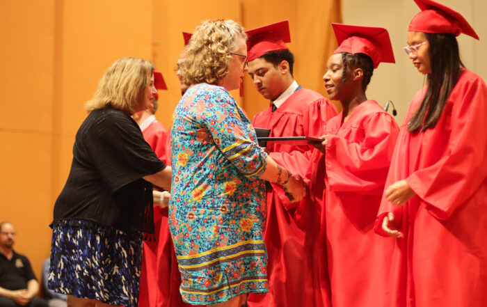 Peggy Sinclair-Morris and Robin Fields Kinney give diplomas to the Kentucky School for the Blind's 2024 graduating class