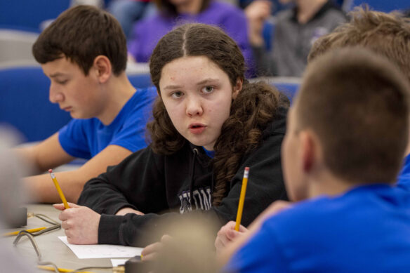 A girl speaks to another student