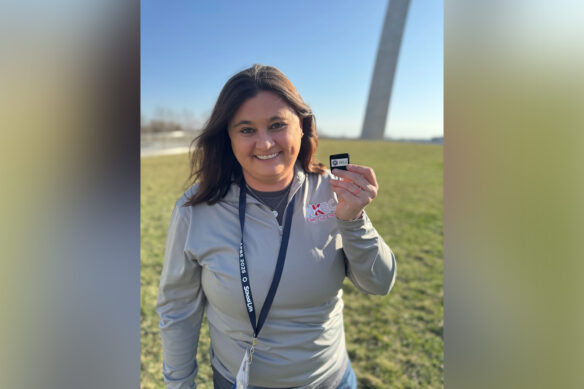 Kayla Jones holds a medallion that says "Under 40 to Watch"