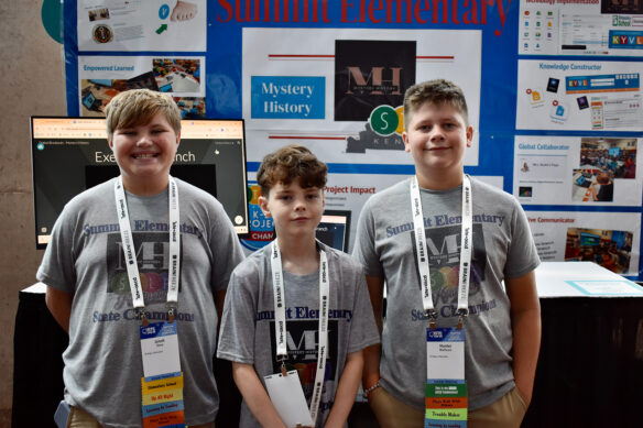 Three kids pose for a photo