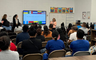 A woman talks to a classroom full of people