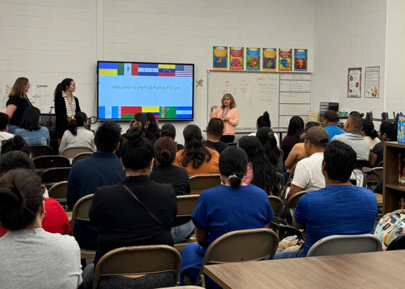 A woman talks to a classroom full of people