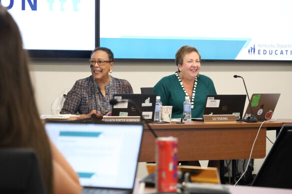 Lu Young and Sharon Porter Robinson laugh while sitting at a table