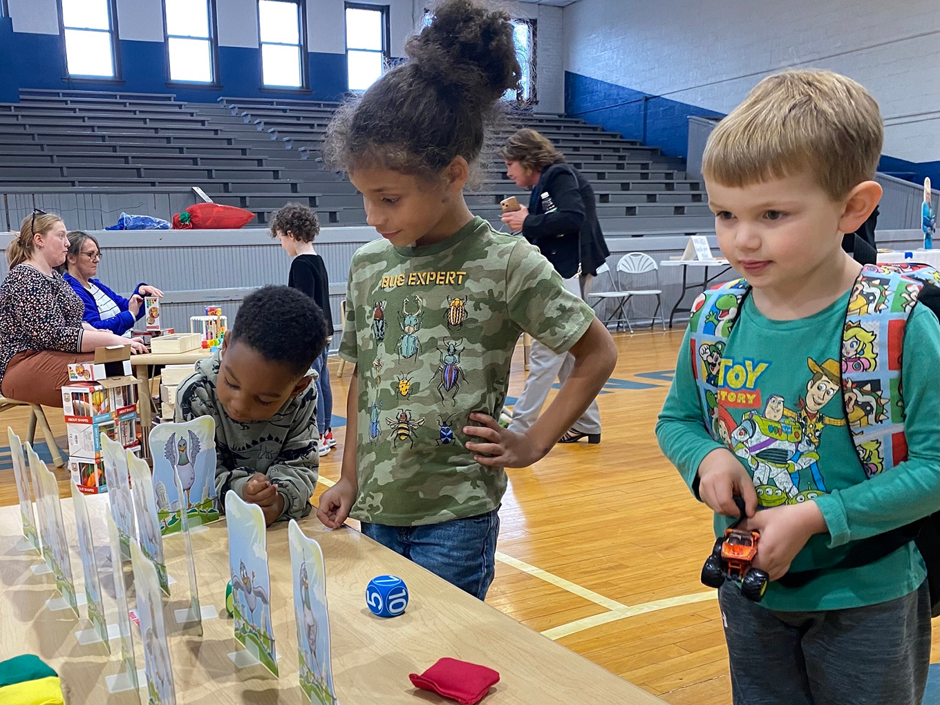 A group of kids play with toys on a table