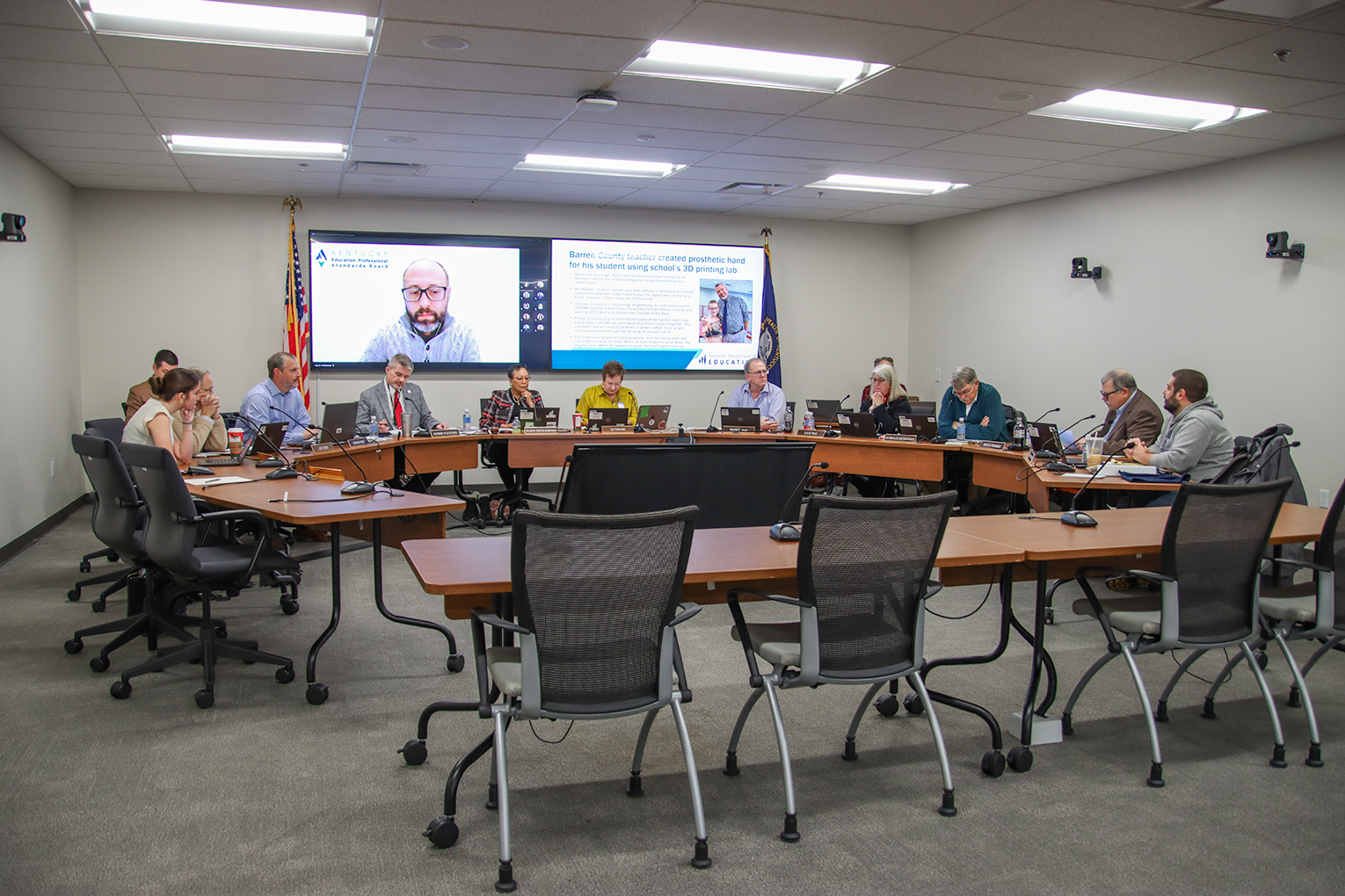 KBE members sit around the board room