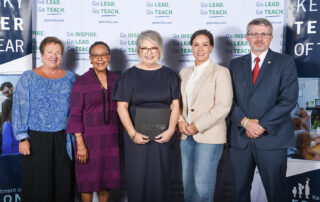 From left to right, Lu Young, Sharon Porter Robinson, Jacqueline Coleman and Robbie Fletcher pose for a photo as Coffey holds a black folder with the Kentucky Department of Education logo on it
