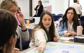 A Kentucky United We Learn Council member pointing to a diagram on a table.
