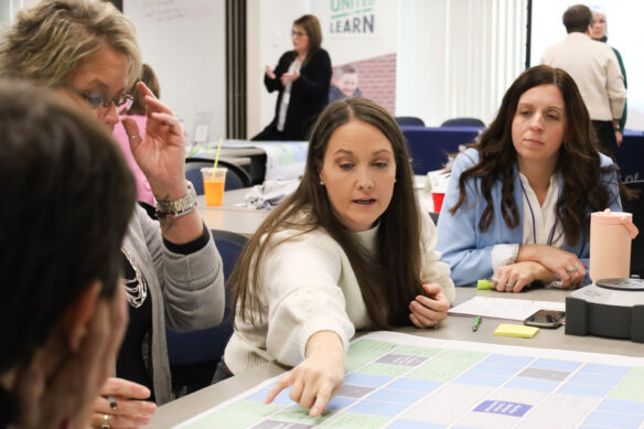 A Kentucky United We Learn Council member pointing to a diagram on a table.