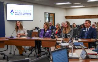 Group of individual address people from a table with microphones