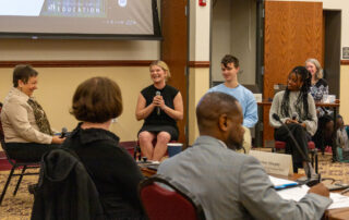 From left to right, Kentucky High School Transformation Work Group Member Lu S. Young shares a laugh with Elkhorn Crossing School students Cathrynn “Cat” Hager, Titus Smith and Maya Felton during the work group’s discussion on the school’s programs.
