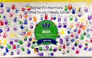 A mural with handprints in different colors and the words "Taylor Elementary Certified Family Friendly School" on it