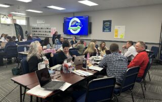 A room of people sitting at tables