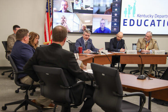 Group of people sitting around a table having a discussion.