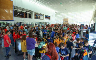 Hundreds of people fill a concourse