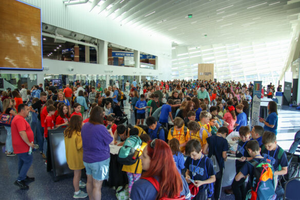 Hundreds of people fill a concourse