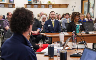 Tyler Saylor, left, an English language arts teacher at Harlan High School (Harlan Independent) and GoTeachKY Ambassador, talks with members of the Education Professional Standards Board about teacher retention. Photo by Joe Ragusa, Kentucky Department of Education, April 21, 2026
